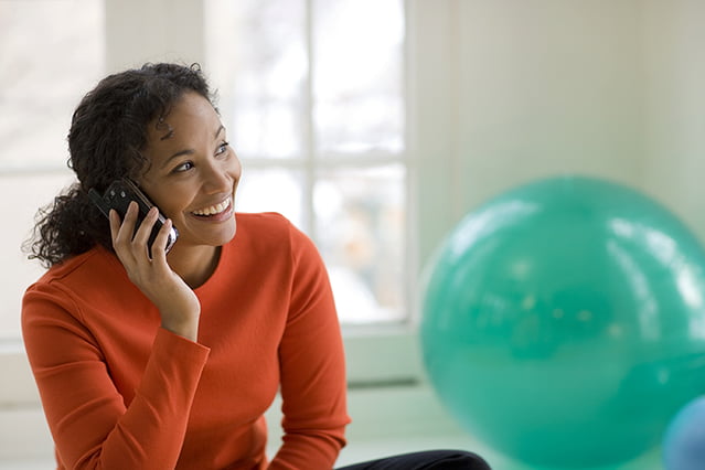 Black woman on cell phone Vexus Phone Customer enjoying unlimited local calling
